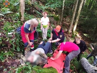Рятувальники транспортували до автомобіля екстреної медичної допомоги постраждалого чоловіка, що впав з квадроцикла в гірській місцевості